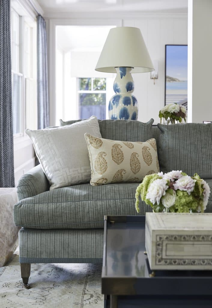 Custom upholstered sofa with contrast pillows, fabricated in our workrooms