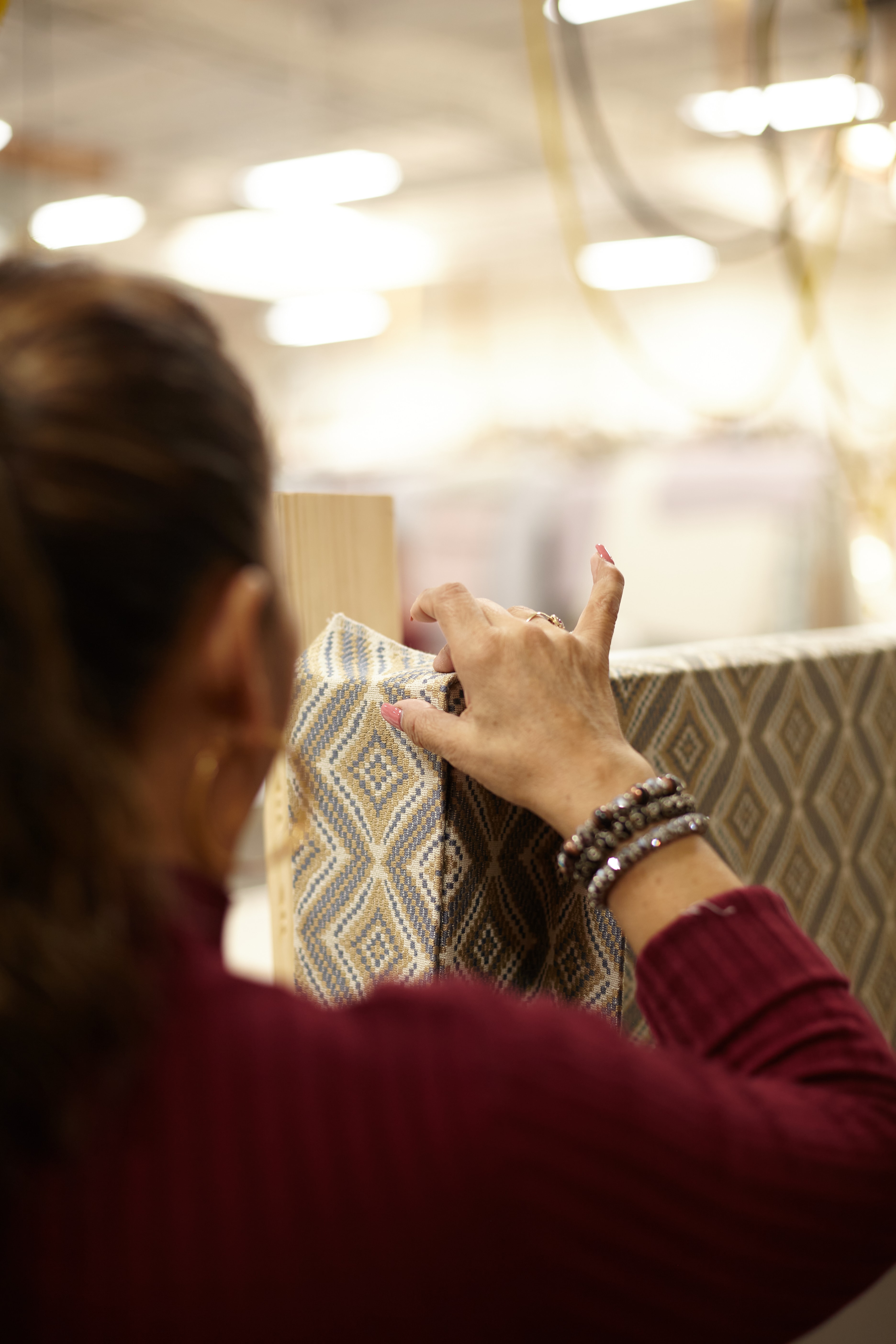 A Valley workroom craftsperson carefully working fabric by hand