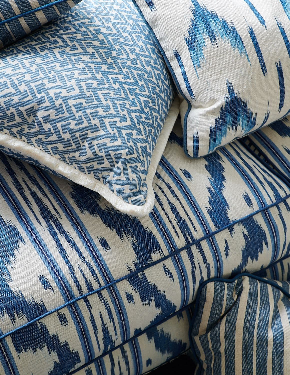 Detail of patterned sofa with custom throw pillows